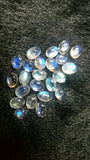 5X7MM Rainbow Moonstone smooth Oval cabs ,pack of 5 pcs , transparent and blue fire quality , grade AAAA