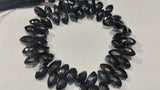 Markis faceted Black Spinel good Quality briolette , Size of Markis shape 6x11MM . Length of strand 10 Inch