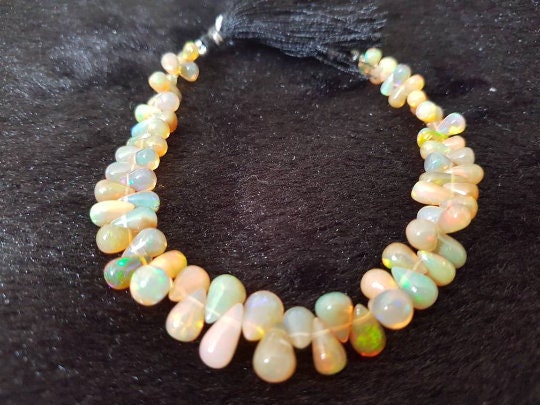 ETHIOPIAN OPAL Drops  Size 4X5MM to 7X11 mm Top Quality drop shapes. 8 Inch Strand , Strong fire , 61 carat weight