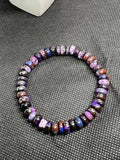 Sugilite roundel 8MM bracelet, stretch cord bracelet, length 7.5”, genuine sugilite, not dyed or treated. 100% genuine